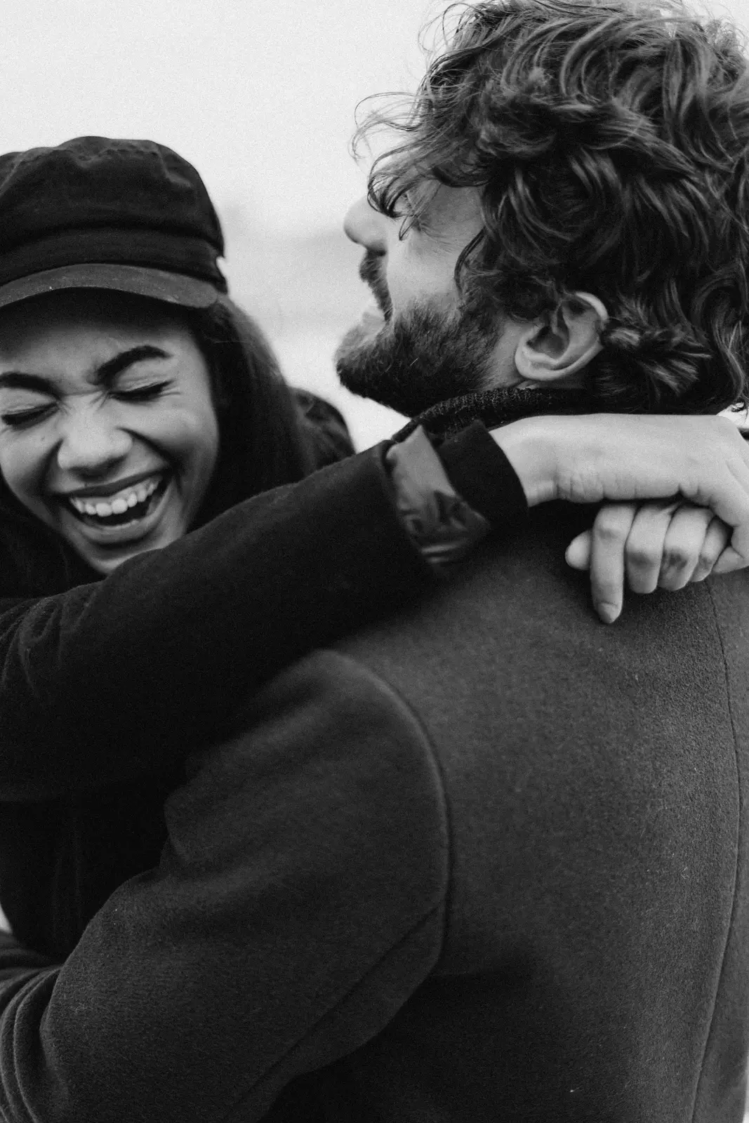 Black-and-white photo of a couple sharing a joyful embrace